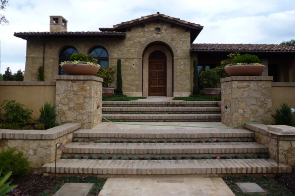 Milan Blend natural stone veneer on custom home exterior with arched entry